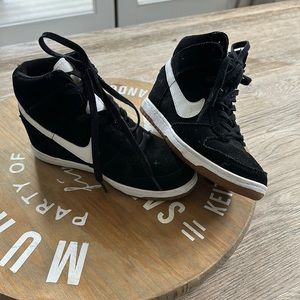 Black and white suede wedge Nikes.